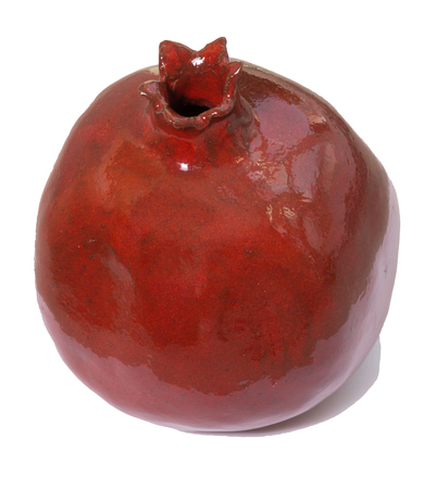 Ceramic red pomegranate isolated white. Gift for Jewish new year (Rosh ha shana). Israel traditional ceramic gift.の写真素材