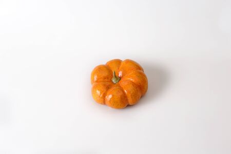 Orange halloween pumpkin gift on white background.の写真素材