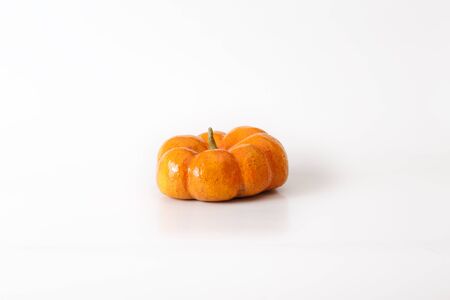 Orange halloween pumpkin gift on white background.の写真素材