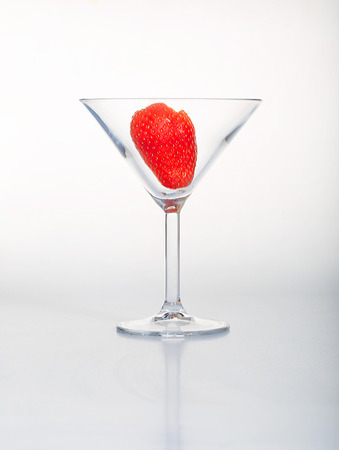 Strawberry in cocktail glass on white background.の写真素材