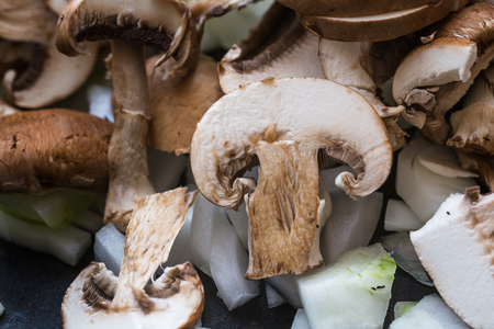 Cut mushrooms with onion. Mushrooms champignon prepared for thermal preparation.の写真素材