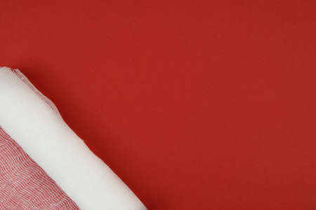 The unfolded bandage lies in the left corner of the frameの写真素材