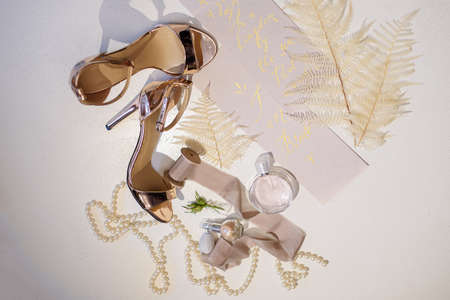 Wedding details of the bride: shoes, perfume, pearlsの写真素材