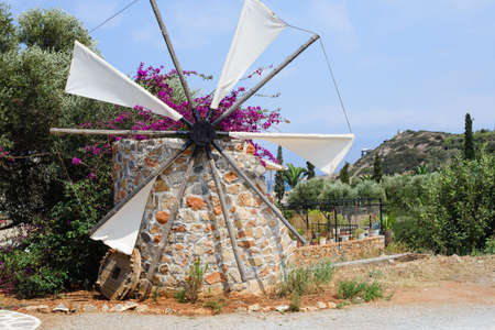 Decorative windmill with petunias growing on it. Greece, Crete. High quality photoの写真素材