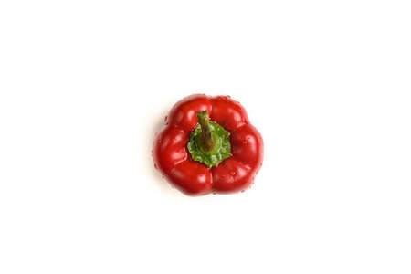 One sweet red pepper with water droplets isolated on a white backgroundの写真素材