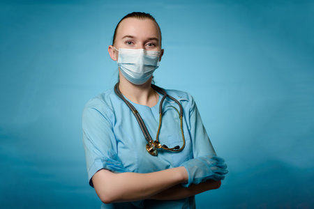 Doctor wearing gloves on a blue background with stethophonendoscopes on his neck