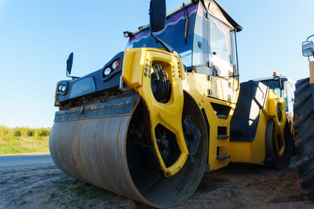 Asphalt concrete roller for compacting and leveling the asphalt concrete mix layer.