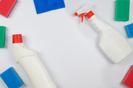Layout of colored sponges and bottles, sprays for house cleaning.Copy space