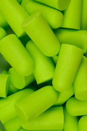 Lots of soft light green foam earplugs. Soft foam ear plugs.Close-up.The concept of getting rid of...