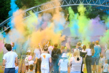 BELARUS,Mogilev - July 2,2022:A group of happy people at the Holly Colors carnival.People throw Holi colors into the airのeditorial素材