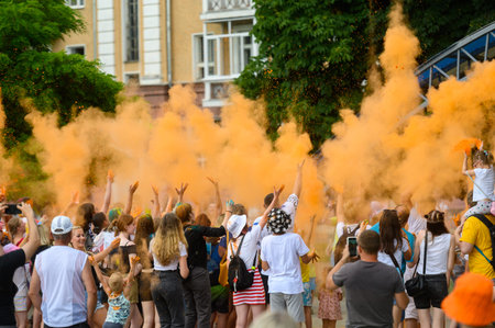 BELARUS,Mogilev - July 2,2022:A group of happy people at the Holly Colors carnival.People throw Holi...
