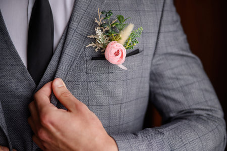 Portrait of a man straightening his jacket with his hand. No face.The concept of male style, grooms...