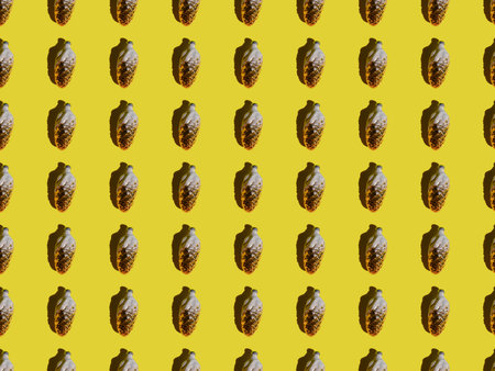 Pattern Christmas cone, Christmas tree toy glass on a yellow background. Fractal of a New Year's toy.の写真素材