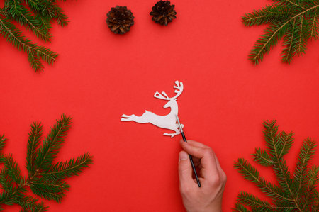 Christmas, winter composition. Frame of fir branches, hand-painted New Year's toy on a red background. Flat lay, top view. The concept of preparing for christmas, winter, new year. christmas wallpaperの写真素材