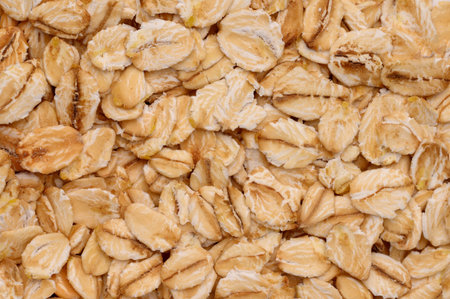 Macro photo of oatmeal.Texture, background of dry oatmeal.Healthy, delicious food, source of amino...