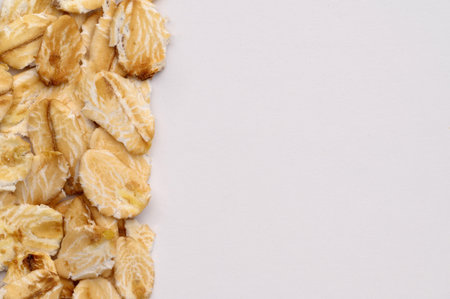 Macro photo of oatmeal on a white background,texture,background.Healthy, delicious food, source of amino acids,minerals, vitamins.Top view. Copy space.の写真素材