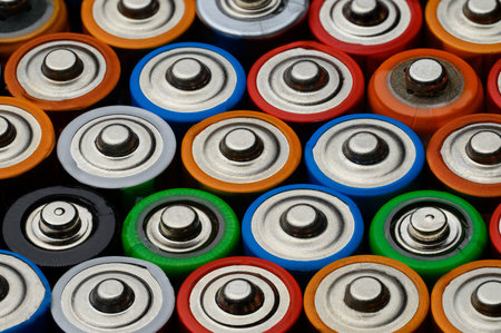 Close-up of batteries, top view. Background of colorful batteries. The concept of dangerous garbage, disposal of used batteries, ecology.Background from colorful batteries.の写真素材