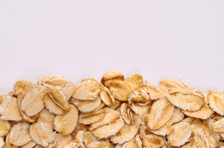 Macro photo of oatmeal on a white background,texture,background.Healthy, delicious food, source of amino acids,minerals, vitamins.Top view. Copy space.の写真素材