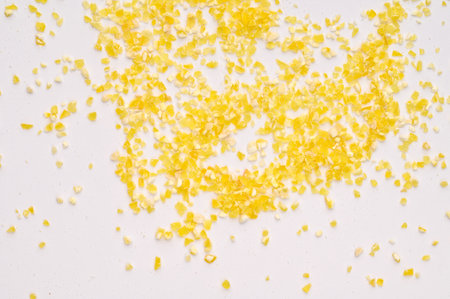 Macro photo of dry yellow corn porridge on a white background. Healthy, delicious food, minerals, natural antioxidantの写真素材