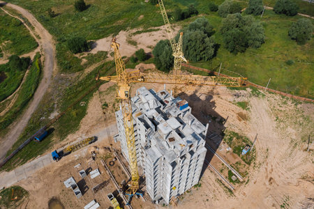 Tower crane builds a residential building, aerial photography. Construction of buildings,...