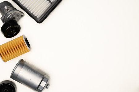 Top view of auto parts, fuel, air and oil filters on white background, tensioner roller. Auto parts replacement concept, auto repair. Copy space.の写真素材