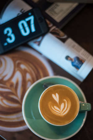 Hot Latte On Magazine with Timeの写真素材
