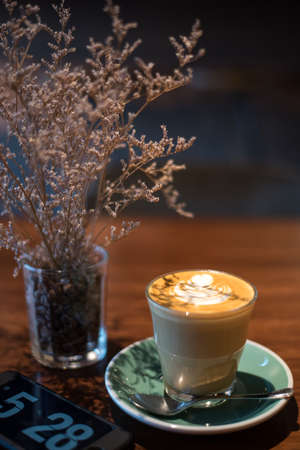 Hot latte and leafの写真素材
