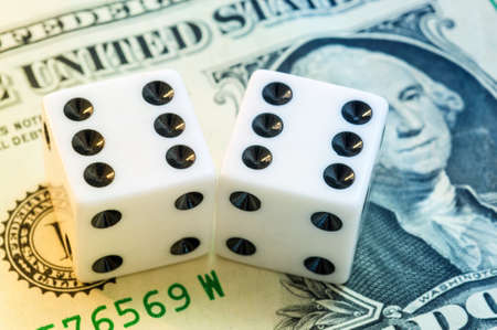 Close up of white dice and dollar cash moneyの写真素材