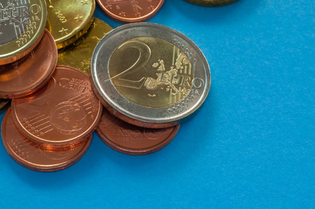 Few Euro coins isolated on blue background