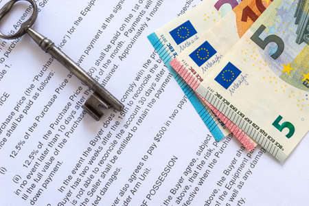 Euro banknote and key on contractの写真素材