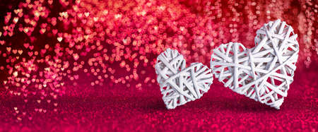 Valentines Day - Wicker Hearts On Red Shiny Backgroundの写真素材