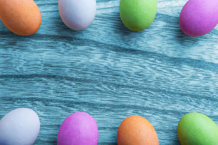 Easter concept with colorful eggs on wooden backgroundの写真素材