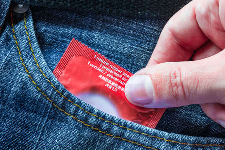 Concept Male Contraception Condom in Jeans Pocketの写真素材