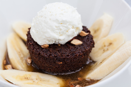 Chocolate brownie with bananas and whipped creamの写真素材