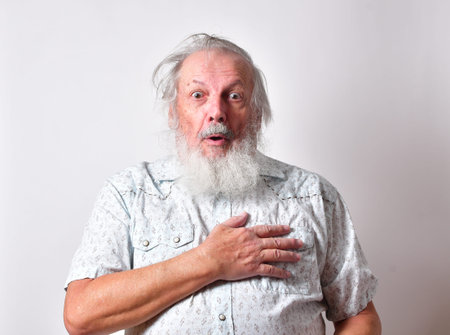 Sad picture of an old man with a long white beard showing extreme physical or mental pain. Concept of medical problems old people suffer from, including mental  pain.の写真素材