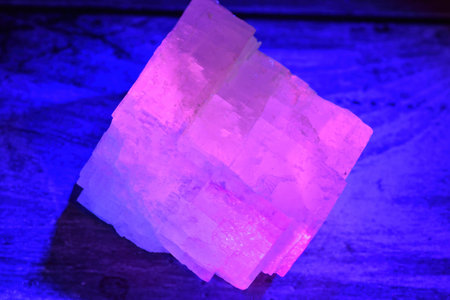 Crystal fluorescing pink under a UV light.