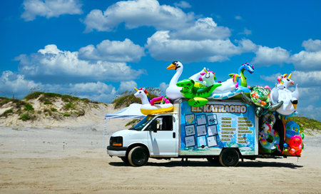 South Padre Island, Texas USA: Circa July 2021   

Vendor selling colorful beach inflatable beach toys from a van.
Fun time beach scene with a vendor's truck loaded with colorful beach toys.のeditorial素材