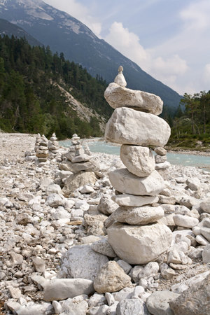 Pyramid of stones beside a riverの写真素材
