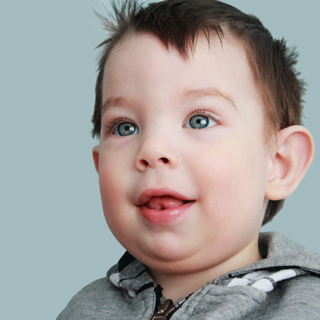 Portrait of funny baby on blue background