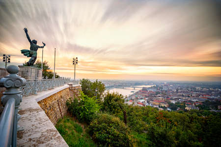 Statue during sunrise facing Danube River in Budapestの写真素材