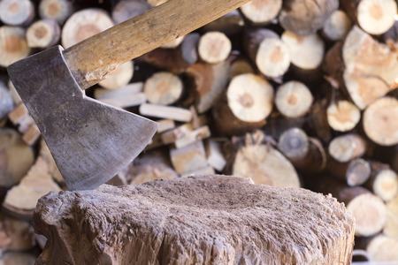 Cutting logs of wood on a large piece of wood. It will help us to warm up in the fireplace.の写真素材