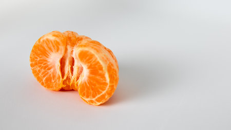 Peeled tangerine or mandarin on a white background.の写真素材