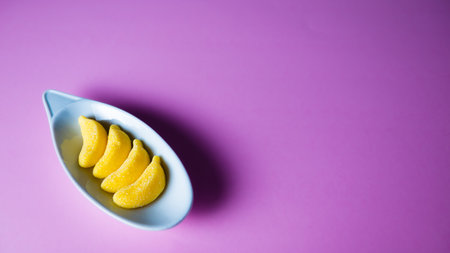 Colorful candies in a bowl on a pink background. Copyspace.の写真素材