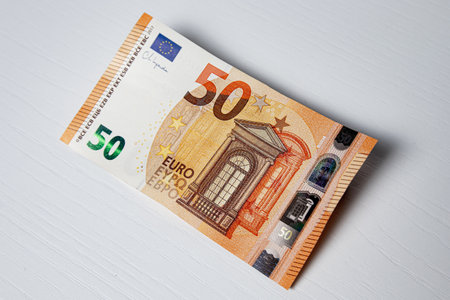 Fifty euro banknote on a white wooden background close-upの写真素材