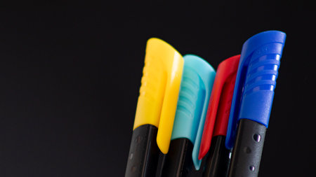 Colorful markers on a black background, close-up, selective focusの写真素材