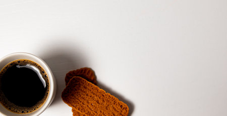 Cup of coffee and cookies on a white background, top viewの写真素材