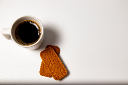 Cup of coffee and cookies on a white background, top viewの写真素材
