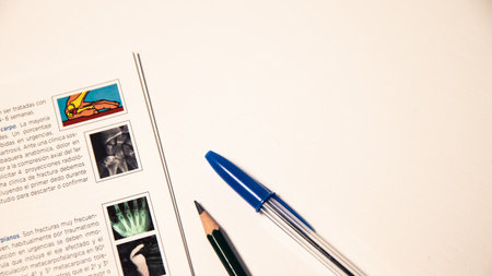 A book with a blue pen next to it and a pen with space for text. Space for studyの写真素材