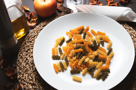 Fusilli pasta in the form of spirals on a white plateの写真素材