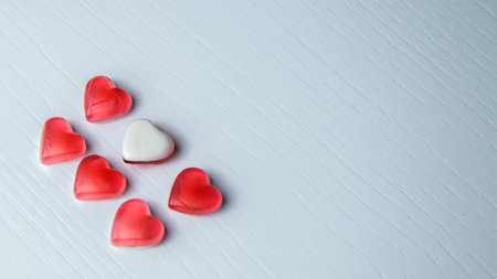 Valentine's day background. Red and white hearts on white wooden background.の写真素材